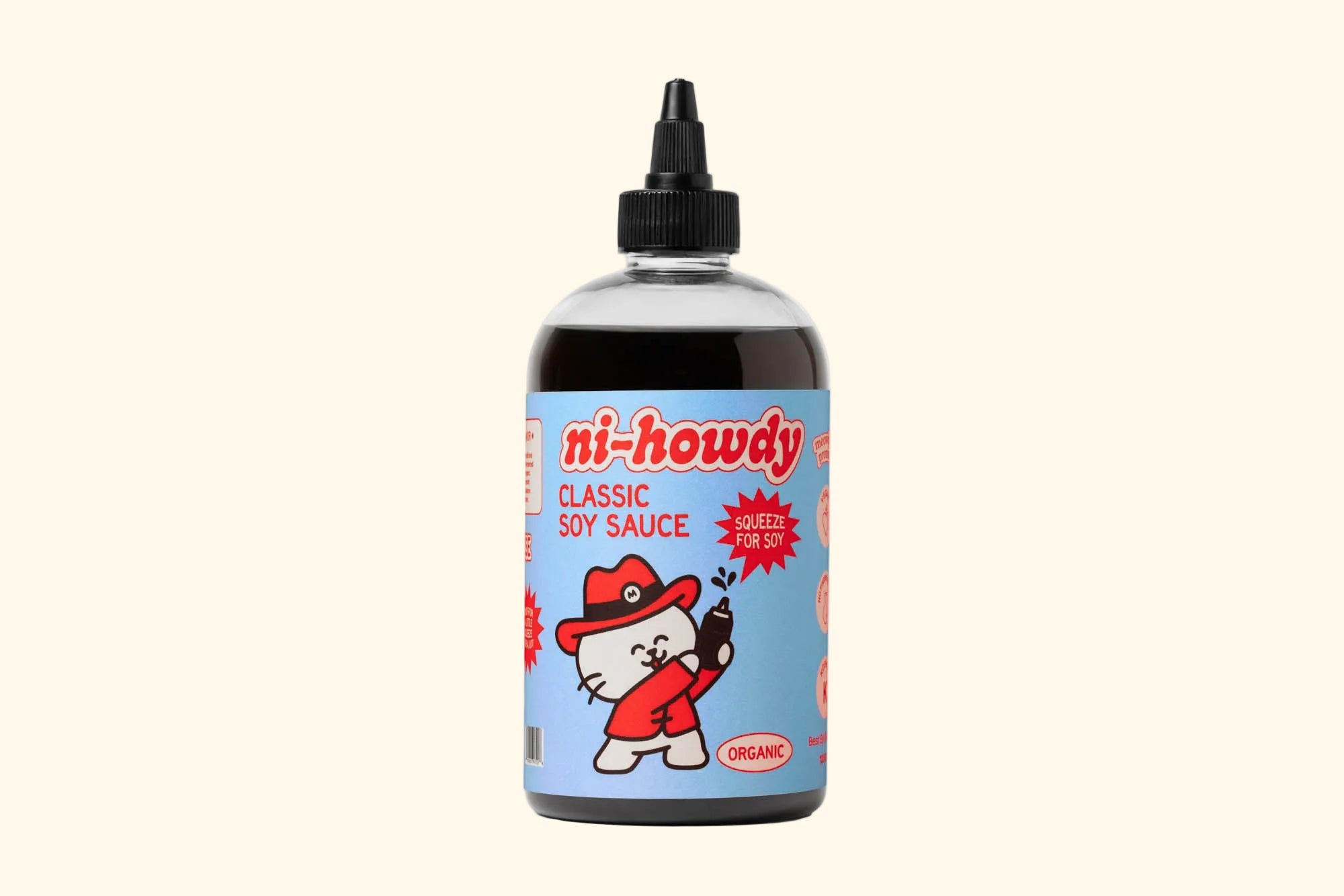 A bottle of ni-howdy Classic Soy Sauce with a black cap and a light blue label featuring a cartoon cat in a red hat, shown on a clean white background.