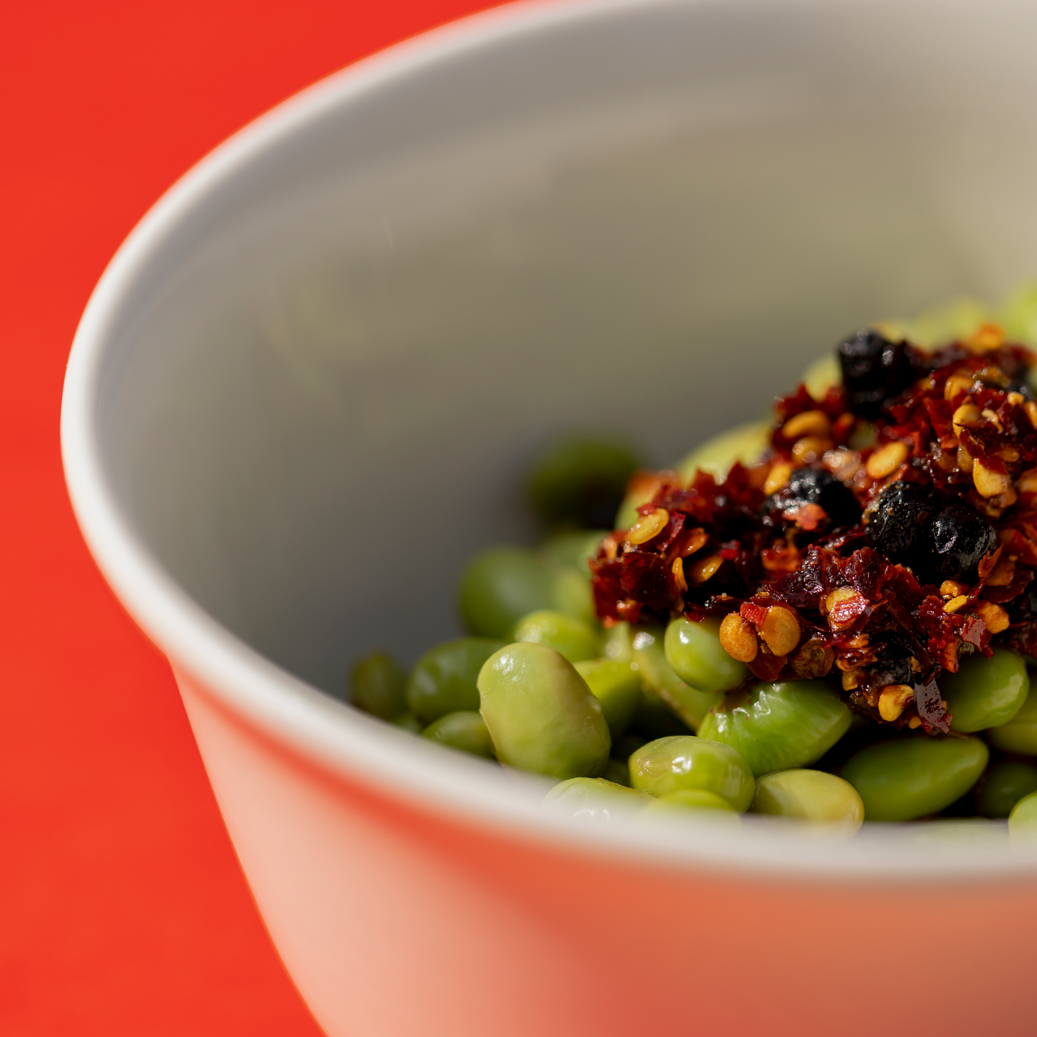 Close-up of Ni-Howdy seed oil free Sichuan chili crunch with chili flakes, spices, and umami texture
