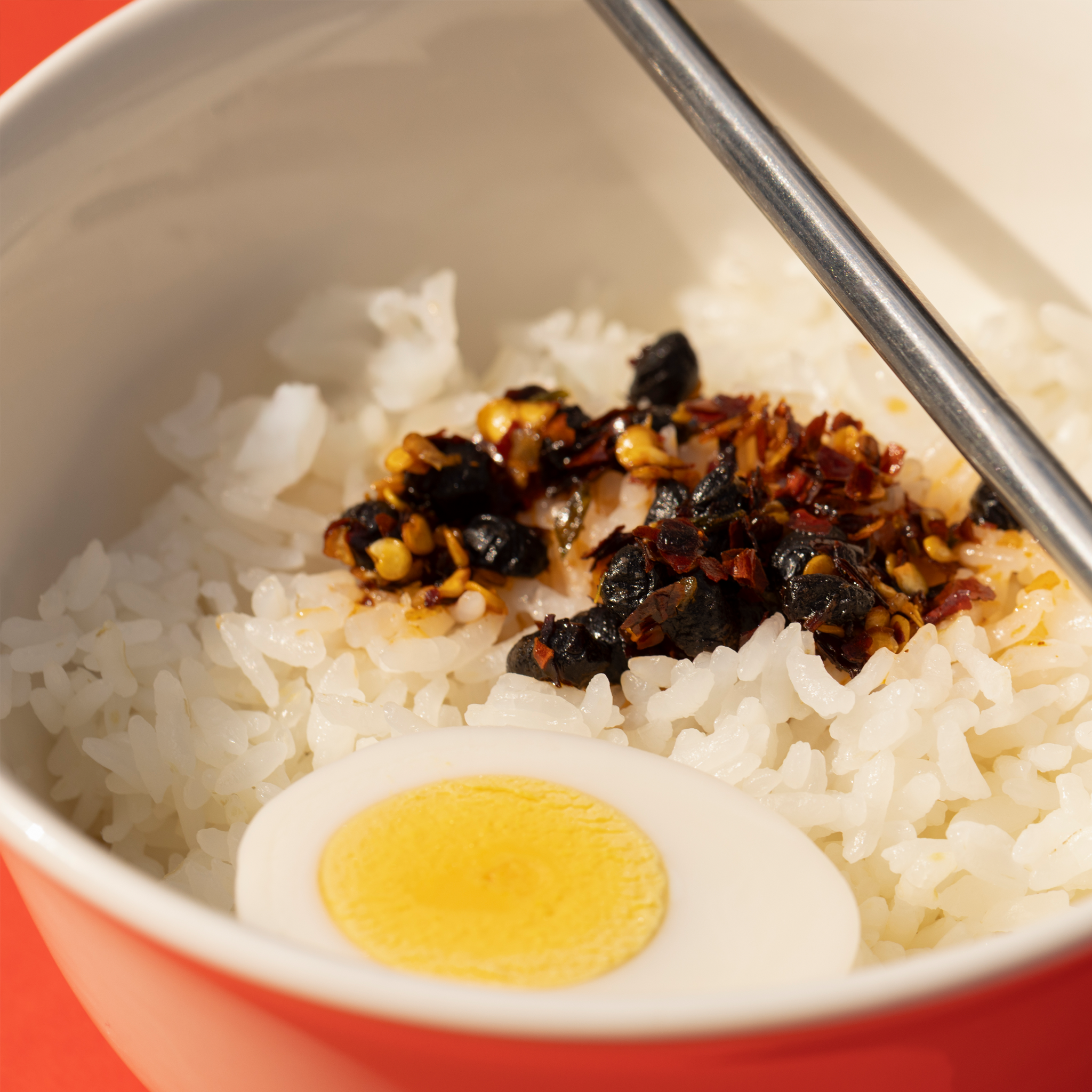 Spoonful of Ni-Howdy seed oil free Sichuan chili crisp showing crunchy chili and spice blend